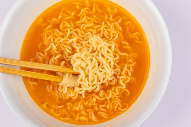 istock A bowl of cooked instant noodle curry taste on white background. 1221140486