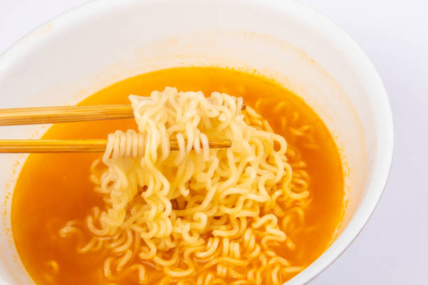 istock A bowl of cooked instant noodle curry taste on white background. 1221140862