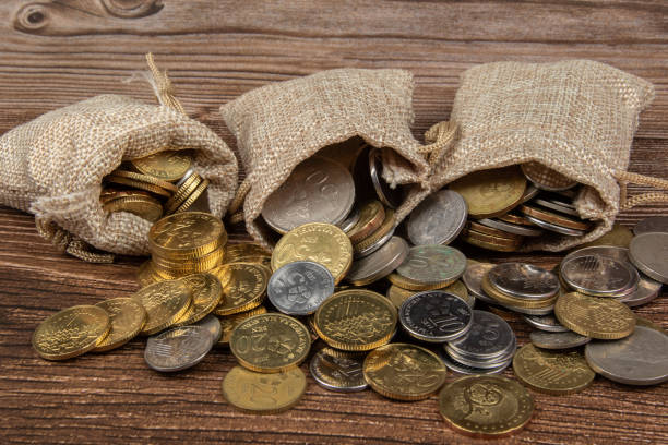 istock sack bag with Malaysia Ringgit coin on wooden table.- Saving Concept 1221140944