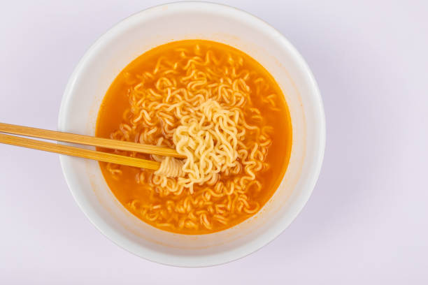 istock A bowl of cooked instant noodle curry taste on white background. 1221141004