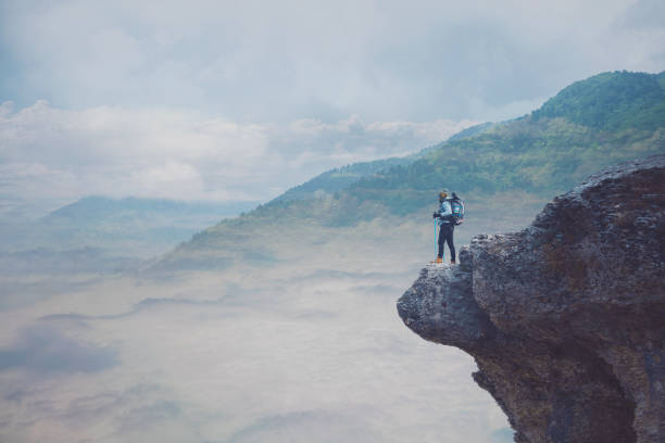 istock Young hiker man over the clouds. 1221143226