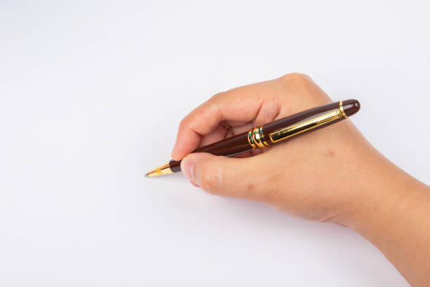 Close up of fountain pen and signature. Selective focus on tip of pen nib
