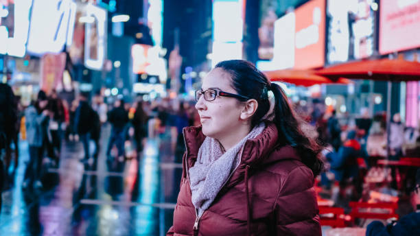 istock Young woman at New York Times by night 1221144975