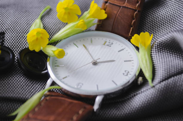 istock Watch with beautiful little yellow flowers 1221147839