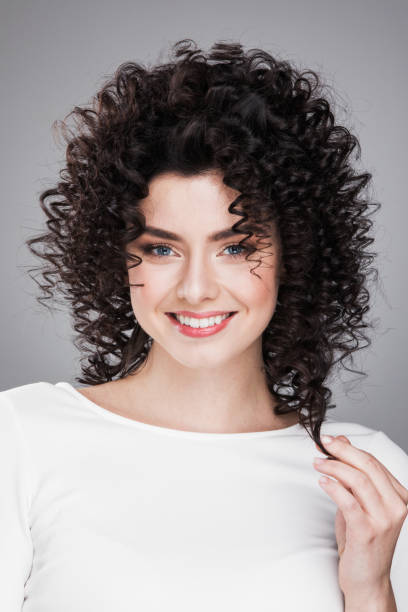 istock Model girl touching her curly hair 1221147936