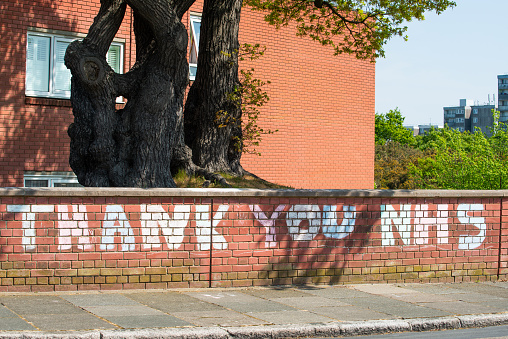 London, UK. 24th April 2020. Large sign chalked on wall outside a residential street, in gratitude to all keyworkers of various professions  who are working during the Coronavirus pandemic.