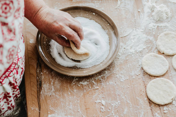 istock Shaping bisquits and sprinkling with sugar. 1221149356
