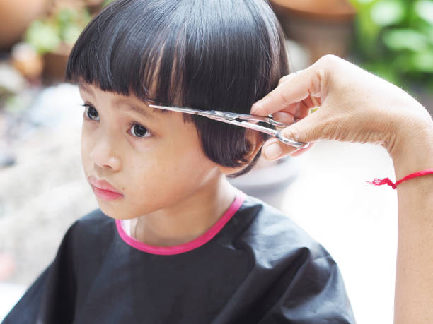 istock girl getting hair cut 1221153112