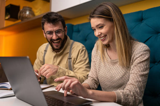 istock Smiling couple working together at home 1221153419