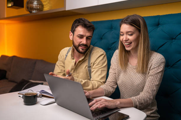 istock Smiling couple working together at home 1221153494