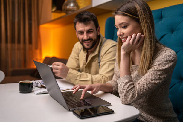 istock Smiling couple working together at home 1221153522