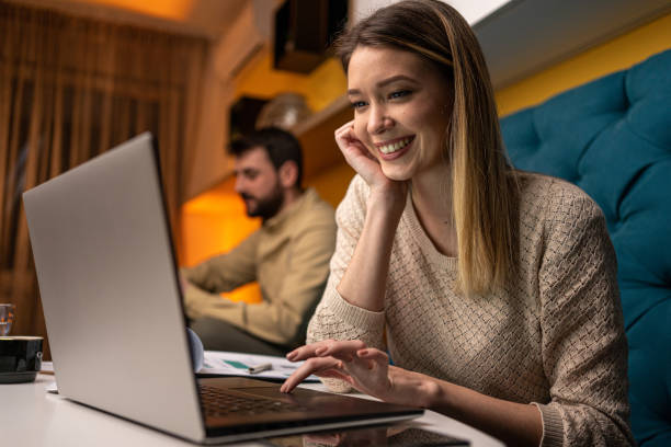 istock Smiling woman working late at home 1221153541