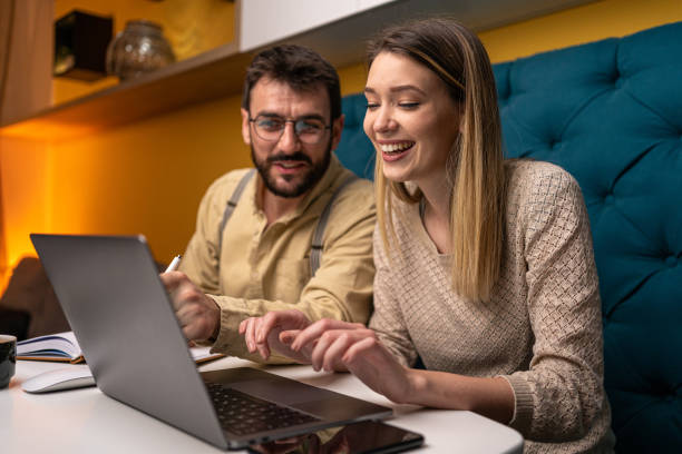 Smiling couple working together at home