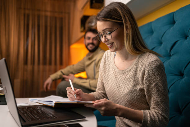 istock Smiling woman working late at home 1221154264