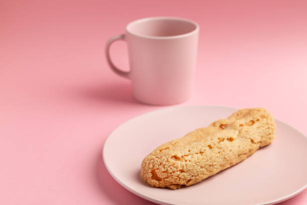 istock Eclair on the plate. Pink pastel background. Dessert concept, minimalism 1221154291
