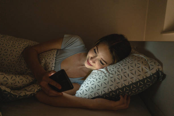 istock Woman in bed using cellphone 1221154340