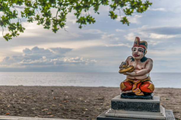istock Colorful Hindu Statue at Beach with sunset in background 1221156272