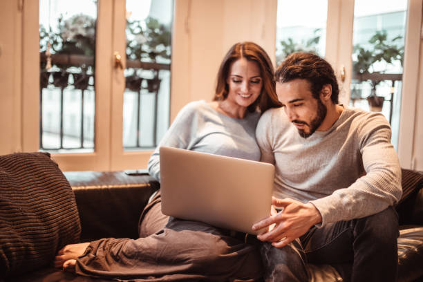 istock couple surfing at the computer during the shutdown 1221157706