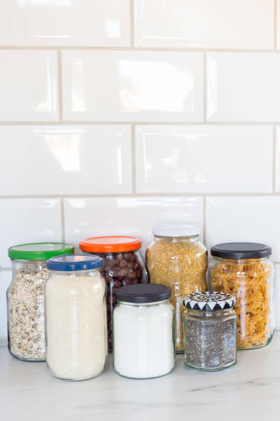 istock Different food in reused glass jars on the kitchen, zero waste plastic free concept, vertical, copy space 1221158991