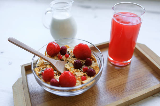 Sweet Wheat Flakes and Strawberries Cereal in a bowl with a spoon