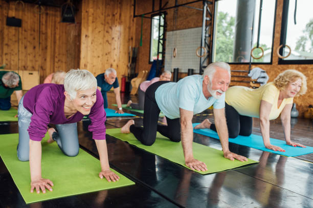 istock Seniors stretching on group yoga class 1221159307