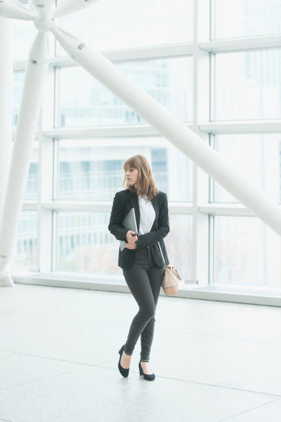 istock young business woman with laptop 1221159541