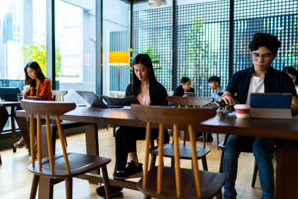 istock Asians Millennials working in busy coworking space 1221160277