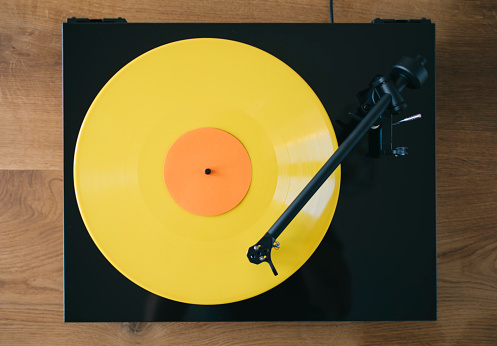 Close up of turntable with gramophone vinyl record playing music.