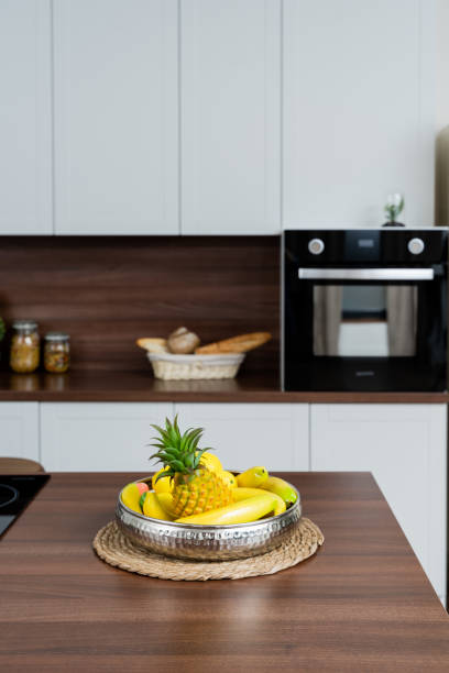 saucepan on a stove with pasta in a white kitchen