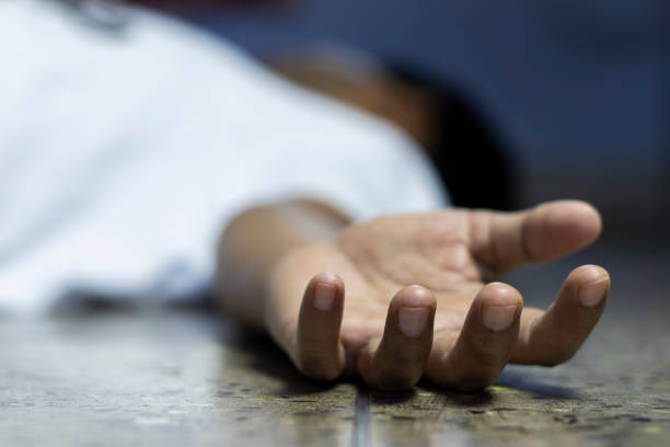 dead body an Indian or Asian person laying on floor dead during COVID-19 or corona virus outbreak with selective focus or shallow depth of field dead stock pictures, royalty-free photos & images