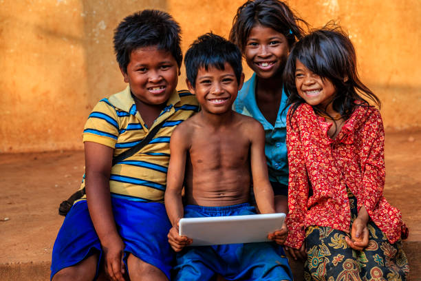 istock Happy Cambodian children using tablet on a schoolyard, Cambodia 1221163516