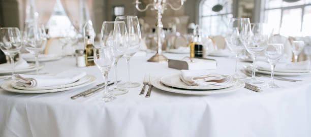 Elegant wedding white table set. Plates, forks and glasses Elegant wedding white table set. Plates, forks and glasses ballroom photos stock pictures, royalty-free photos & images