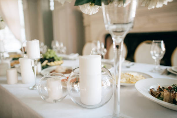 istock Table decor with white flowers and candles for an event party or wedding reception 1221163715