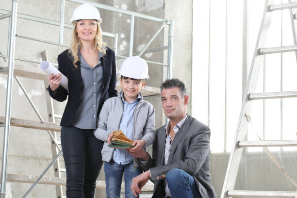 istock Couple of architect and construction engineer together with their son choose the samples to plan the project. House buy and building goal concept 1221165130