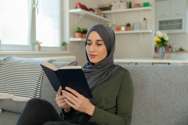 istock Muslim Girl With Hijab Reading a Book 1221166923