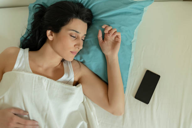 istock Woman With Smartphone Sleeping in Bed 1221167000
