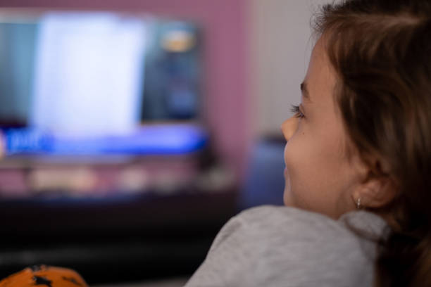 istock Girl at home watching TV 1221168632