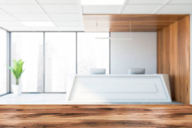 istock Table in blurry white and wooden office, reception 1221170579
