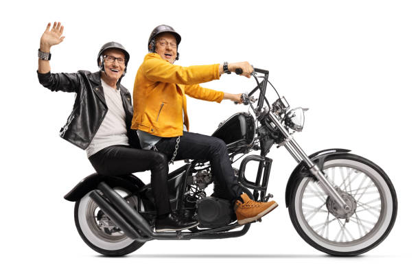istock Two elderly men in leather jackets riding a chopper motorbike 1221171054
