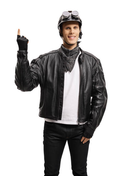 istock Young guy in a bikers leather jacket pointing up 1221171766