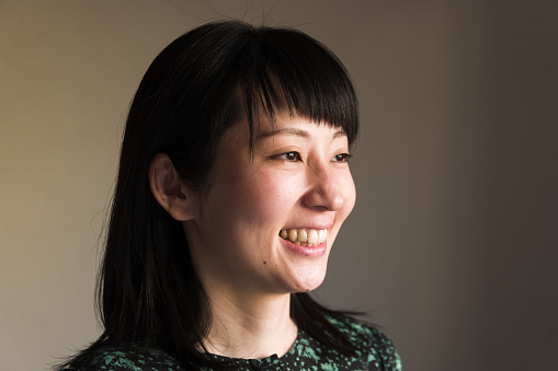 Indoor portrait of young Asian woman. Head close-up.