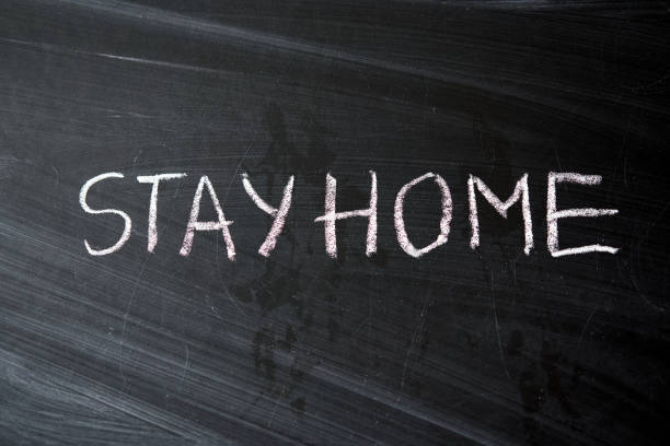 istock Hashtag stay at home. Outbreak Warning. written white chalk on blackboard in connection with epidemic of coronavirus worldwide. 1221173827