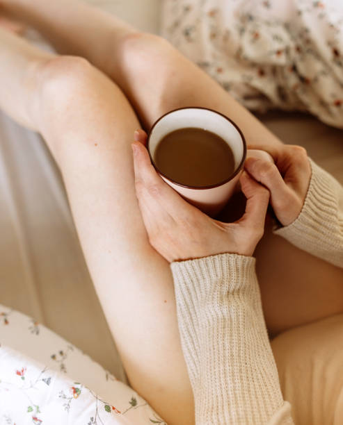 istock Young beautiful woman enjoying with coffee in bed 1221175187