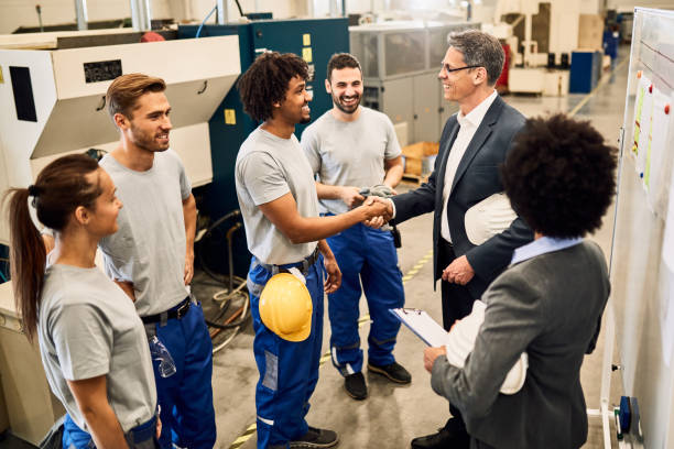 istock Happy company manager greeting with African American worker while visiting a factory. 1221175767