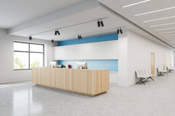 istock Reception and chairs in white blue hospital lobby 1221175827