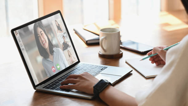 istock Cropped shot woman while video calling with colleague. Working from home through video conference concept. 1221175836