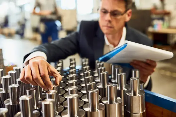 Photo of Close-up of engineer in doing quality control at streel factory.