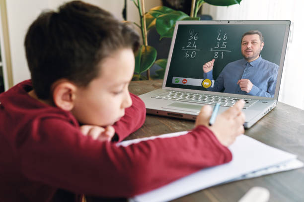 istock 6-7 years cute child learning mathematics from computer. Homeschooling concept. 1221177188