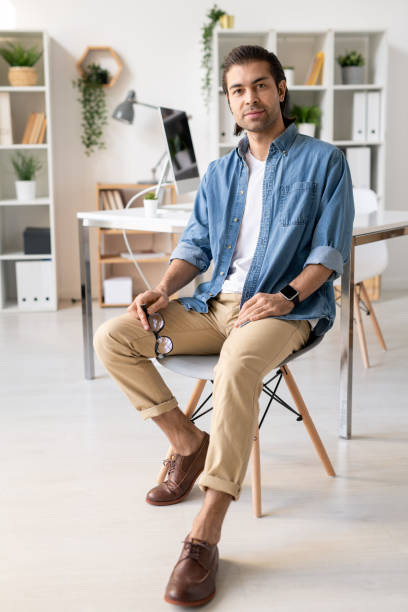 istock Handsome man sitting on chair 1221178291