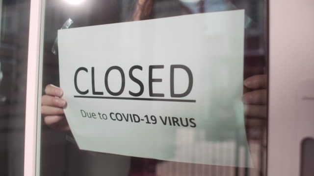 Closed sign on shop door Due to COVID-19 VIRUS, Slow motion
